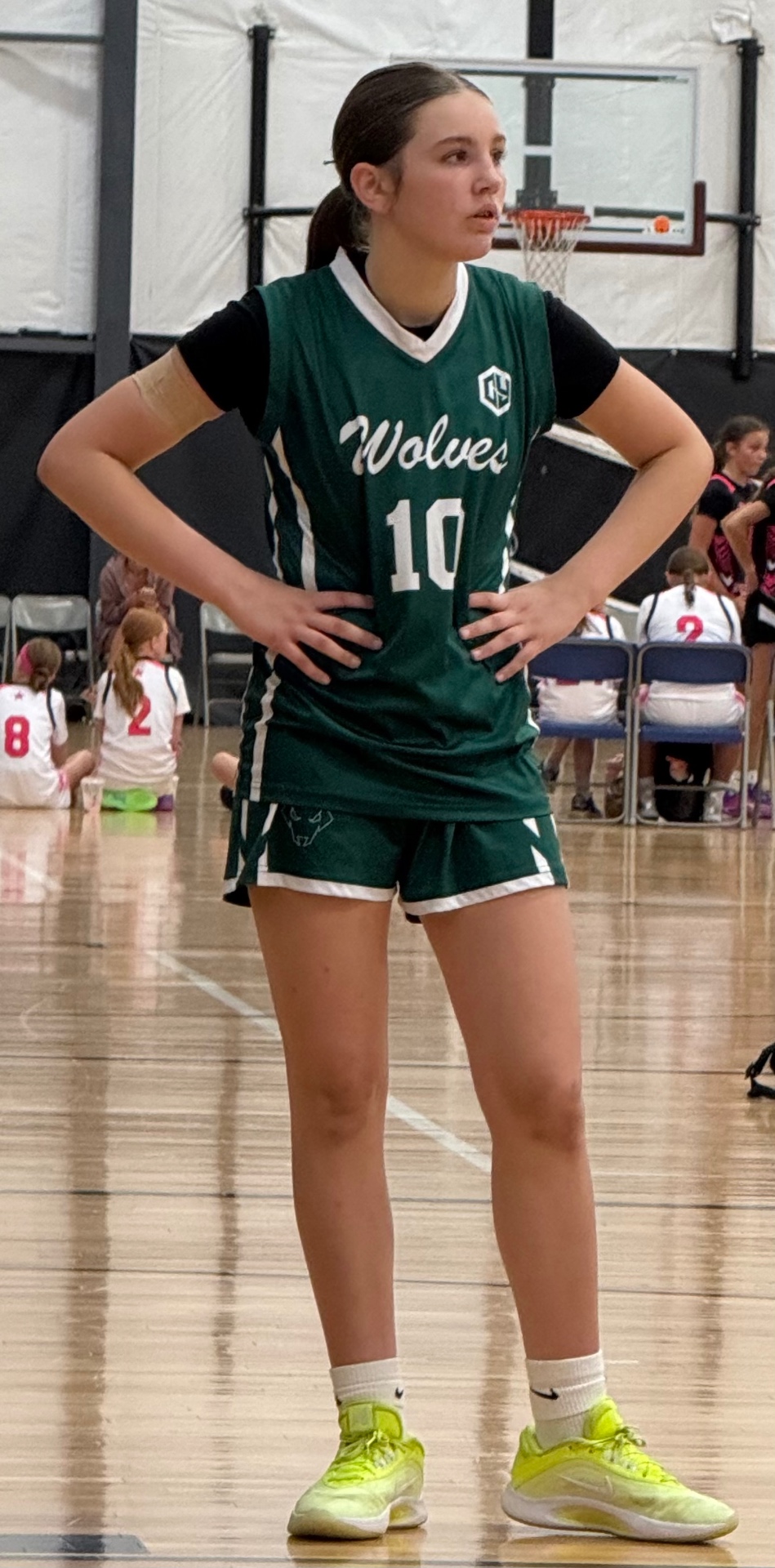 Margo Davis standing on a basketball court in her uniform